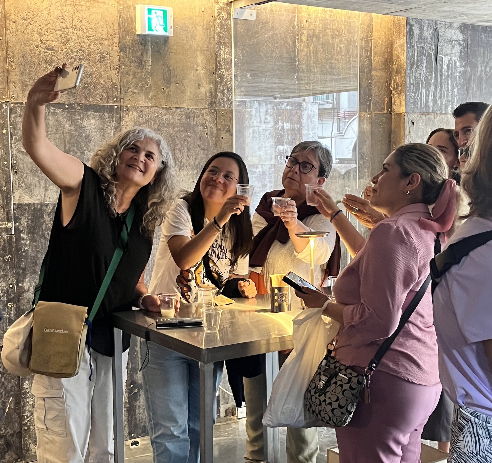 Guests raising glasses of makgeolli around a table inside Chunpoong Brewery
